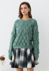 Pull en tricot texturé géométrique à nœud ludique en vert