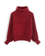Pull en tricot à col roulé avec détails frangés en rouge