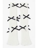 Jambières en tricot à décor de nœud papillon en blanc