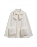 Manteau cape boutonné en tricot avec poche en fausse fourrure et décor de nœud papillon en crème