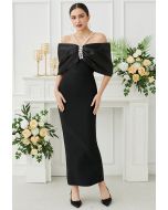 Robe longue noire à épaules dénudées et gros nœud avec décor en strass