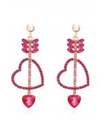 Boucles d'oreilles pendantes Love Arrows en strass magenta